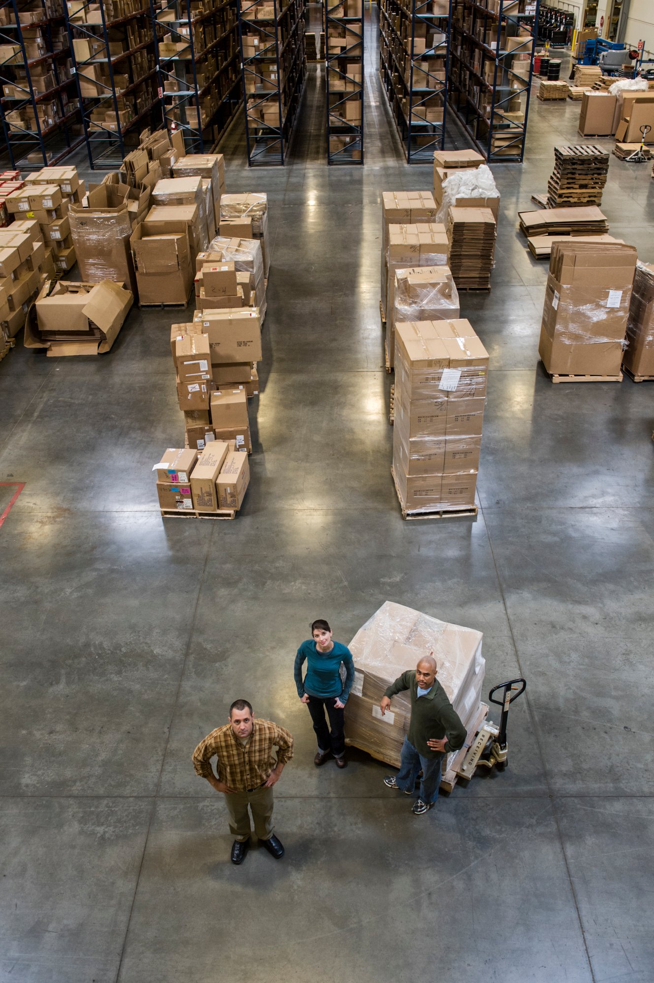 a-group-of-three-warehouse-workers-standing-in-the-2025-04-03-00-35-38-utc-1