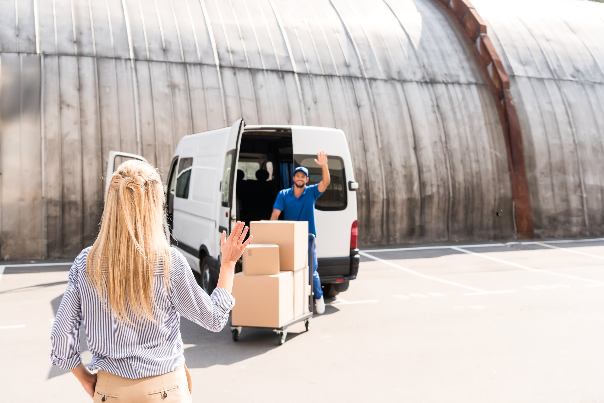 handsome-young-courier-delivering-packages-for-wom-2024-11-18-11-35-41-utc