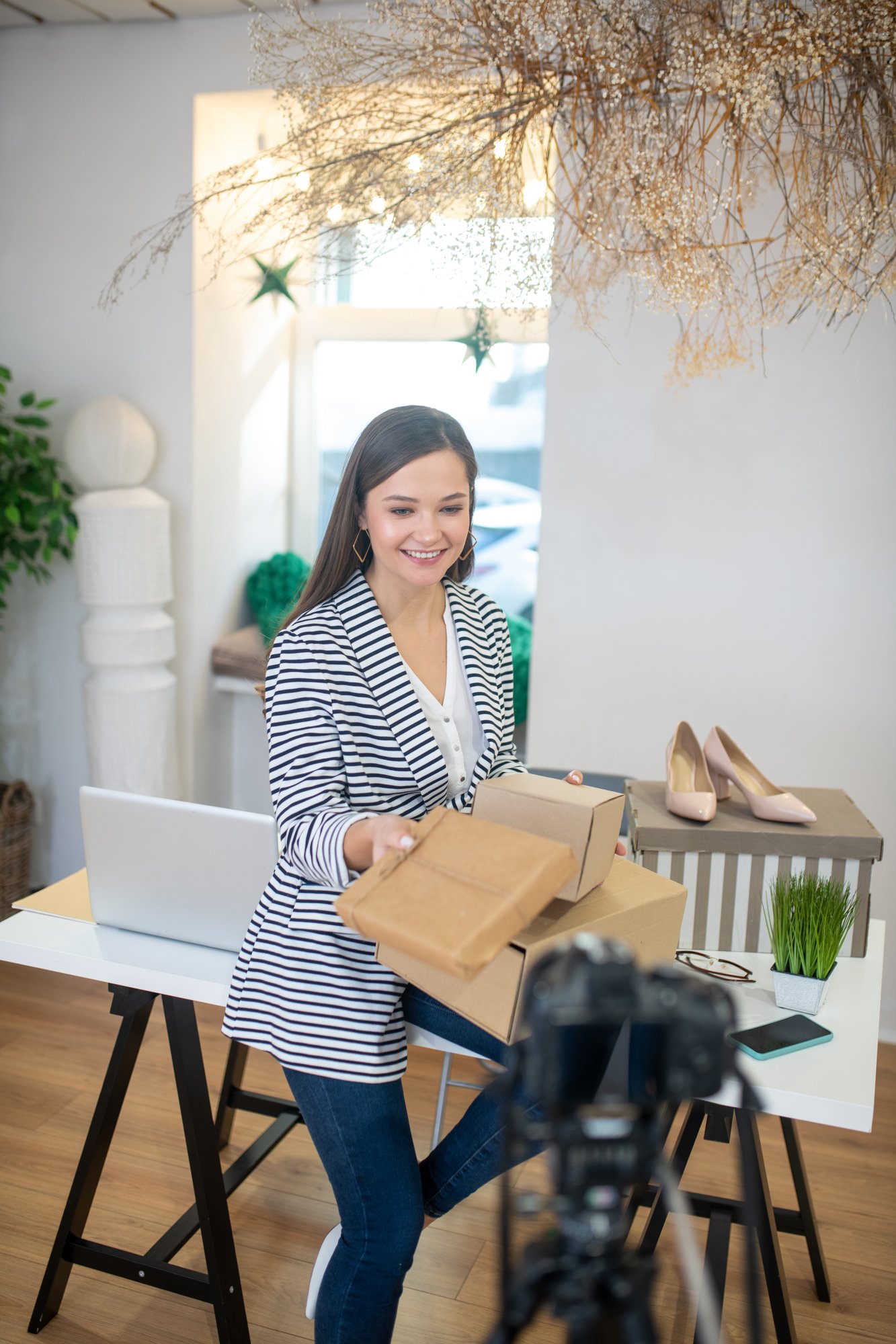 positive-young-blogger-holding-presents-for-her-fo-2024-10-16-23-21-59-utc