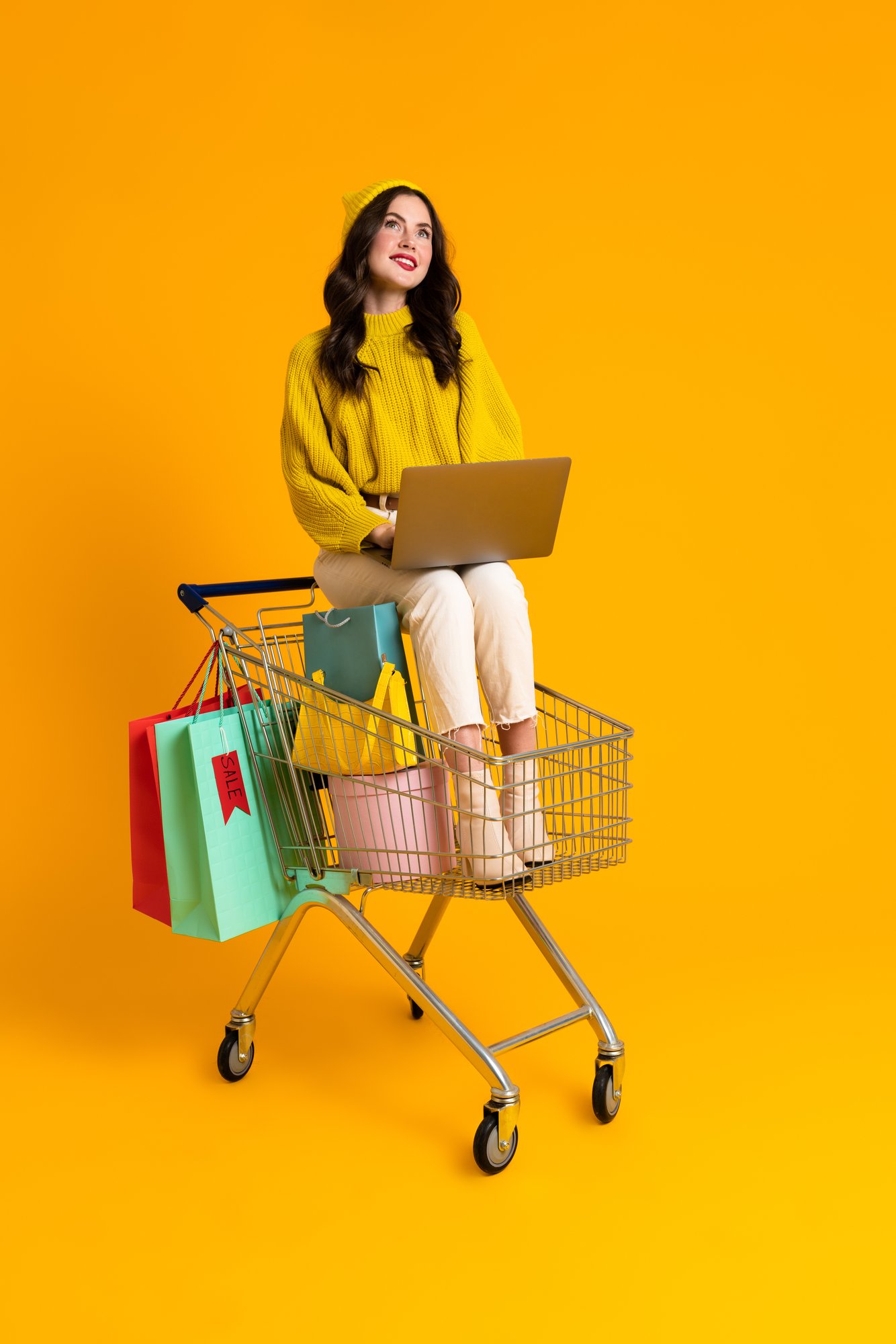white-woman-using-laptop-while-sitting-in-shopping-2025-02-16-18-23-04-utc